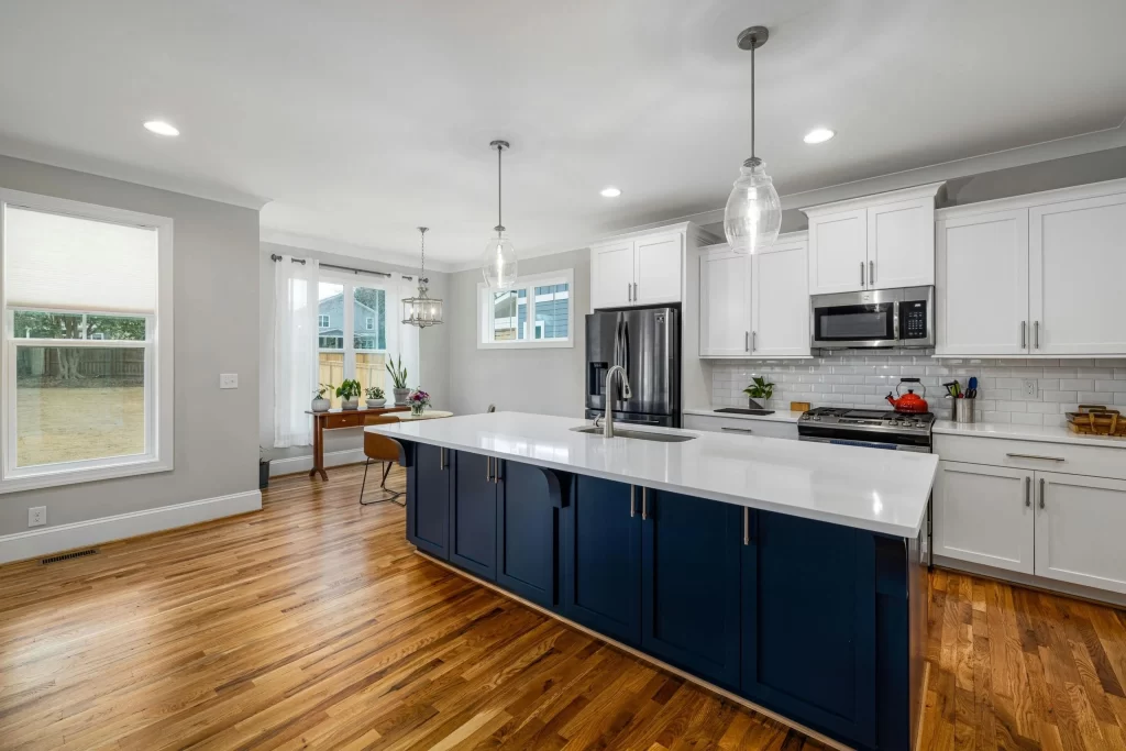 High-end custom kitchen with tailored cabinetry, stone countertops, large island, and integrated modern appliances.