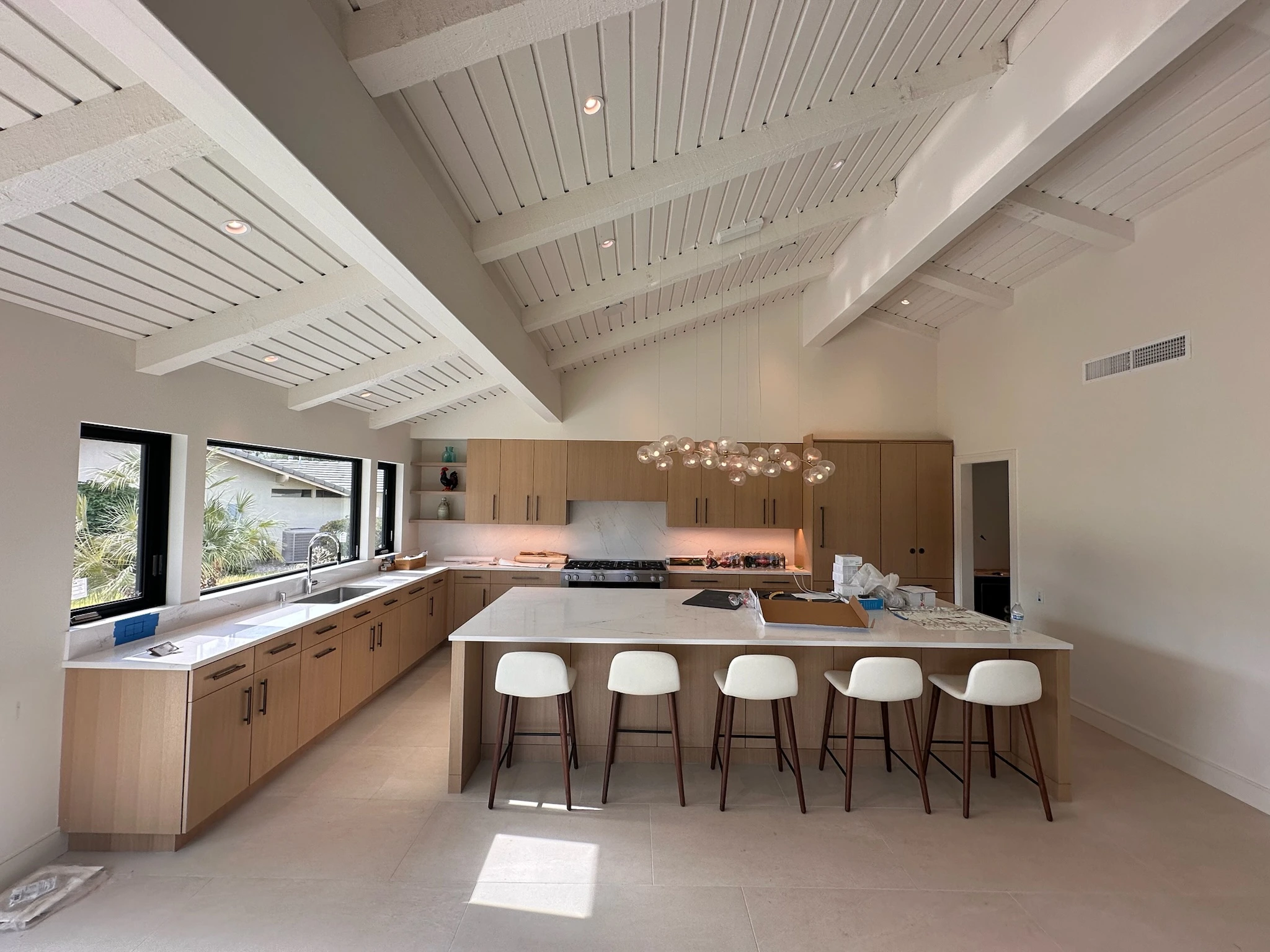 Custom luxury kitchen with tailored cabinetry, spacious island, premium stone surfaces, and refined contemporary finishes.